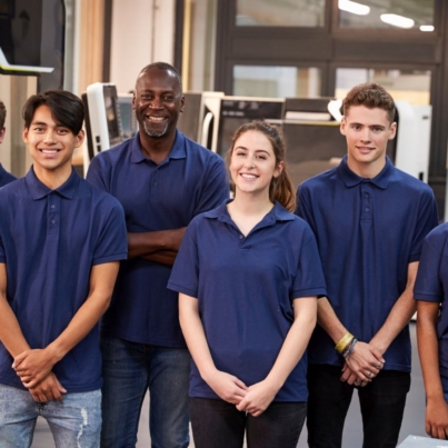 © Monkey Business   ADOBE STOCK - 181153840   Portrait Of Engineer And Apprentices In Factory