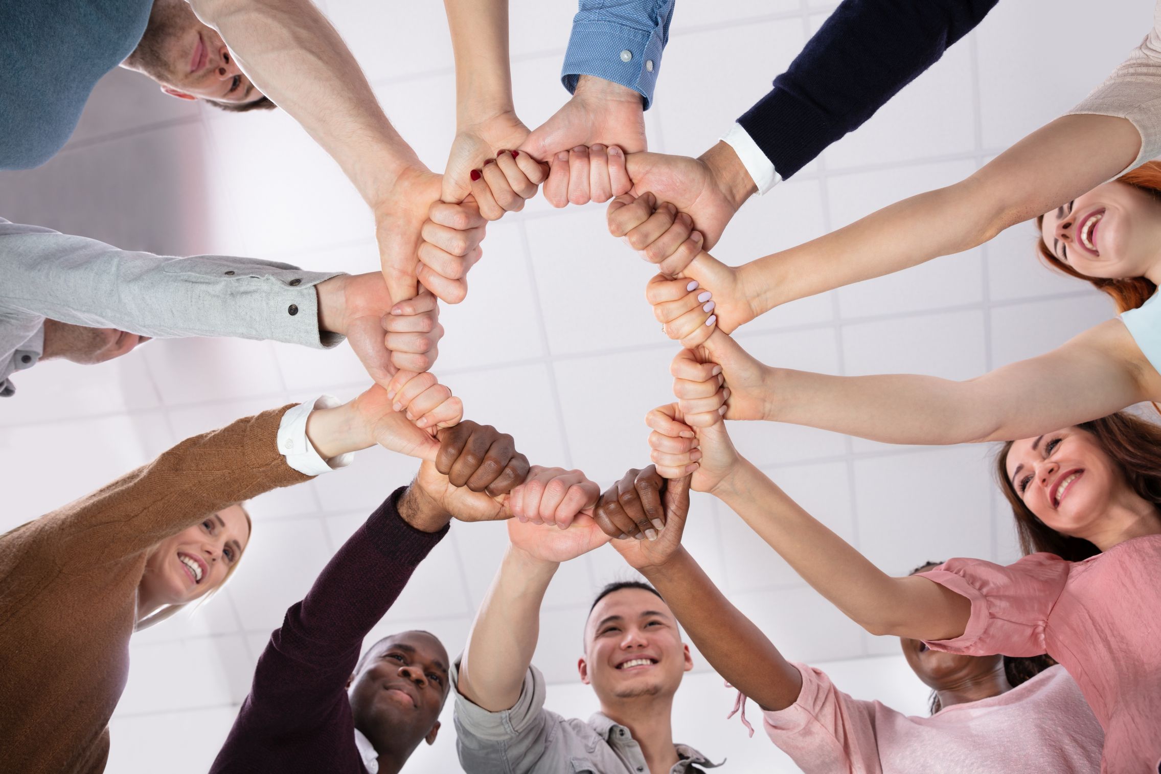 © Andrey Popov  ADOBE STOCK - 274489920   Multi-ethnic Group Of People  Holding Each Other Thumbs Forming Circle