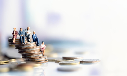 © TimeShops ADOBE STOCK - 322579649   Miniature people: Elderly people sitting on coins stack. social security income and pensions. Money saving and Investment. Time counting down for retirement concept.