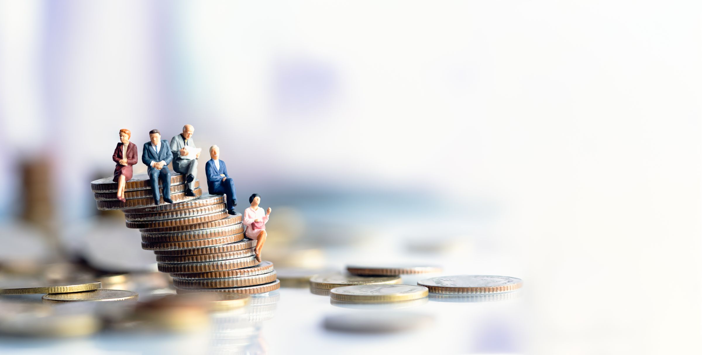 © TimeShops ADOBE STOCK - 322579649   Miniature people: Elderly people sitting on coins stack. social security income and pensions. Money saving and Investment. Time counting down for retirement concept.