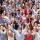 Portrait of crowd cheering with arms raised