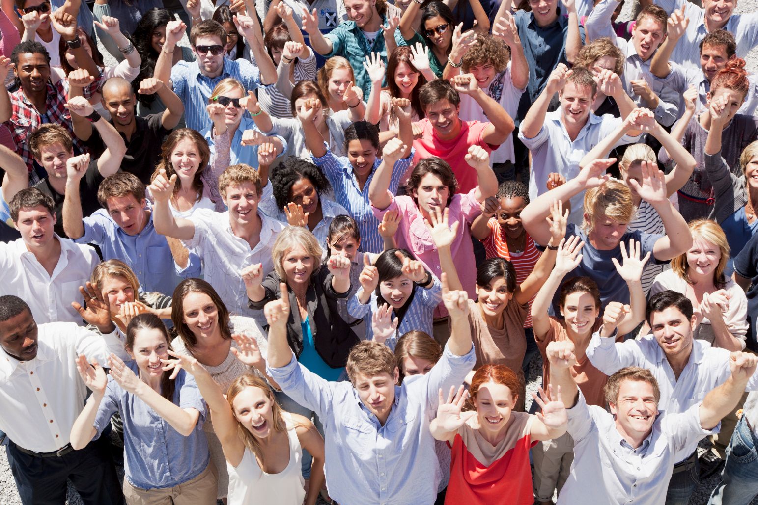 Portrait of crowd cheering with arms raised