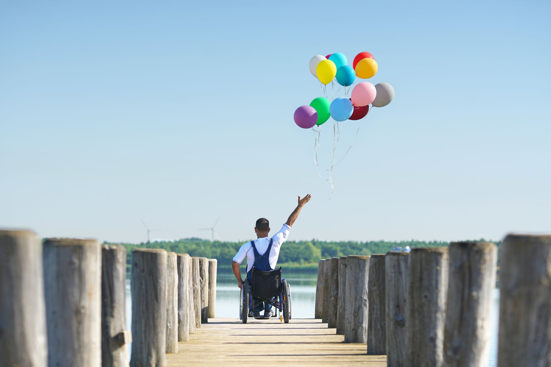 Disabled man sitting in wheelchair showing freedom.